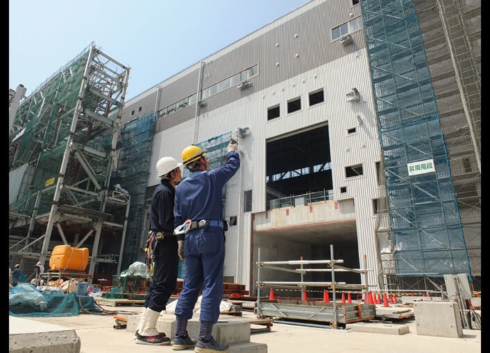 工事状況を確認する協力会社社員と当社社員